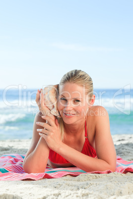 Woman listening to a shell