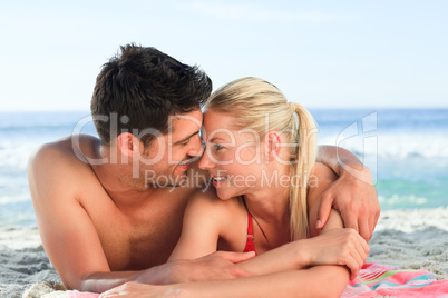 Lovers lying down on the beach