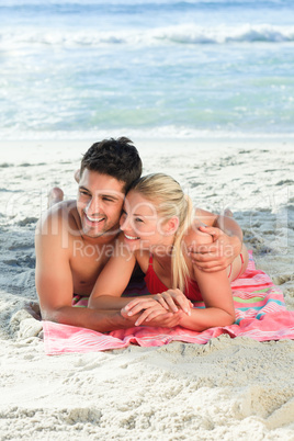 Lovers lying down on the beach