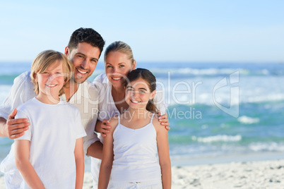 Portrait of a cute family at the beach