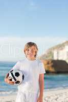Little boy with his ball on the beach