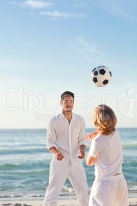 Father playing with his son on the beach