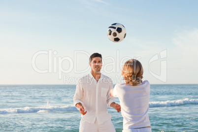 Father playing with his son on the beach