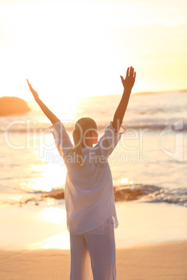 Woman practicing yoga during the sunset