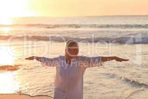 Woman practicing yoga during the sunset