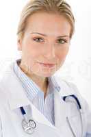 Young female doctor with stethoscope on white