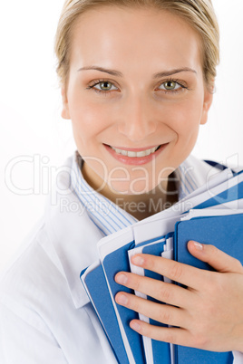 Young female doctor with medical files on white