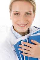 Young female doctor with medical files on white