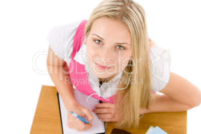 Cheerful student woman write homework