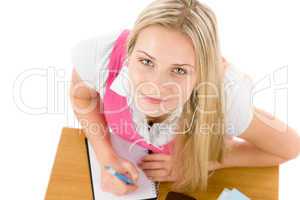 Cheerful student woman write homework