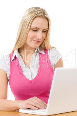 Happy teenager woman sitting at table with laptop Happy teenager woman sitting at table with laptop