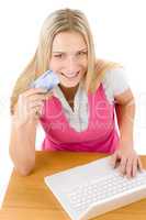 Home shopping - young woman holding credit card