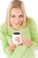 Portrait of happy blond woman with coffee