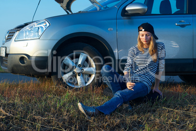 Young Blond Woman With Her Broken Car