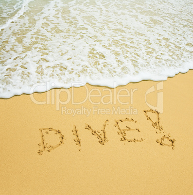 dive written in a sandy tropical beach