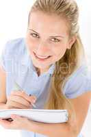 Happy student woman write notes on white