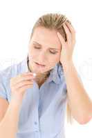 Young woman with headache, migraine take pill