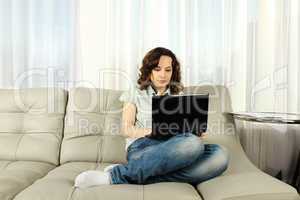Young Woman on Couch with Laptop