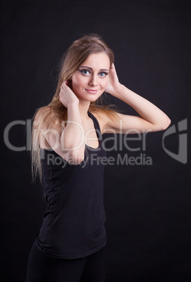 Young beauty blond girl in black tank top