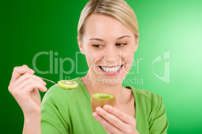 Healthy lifestyle - happy woman holding kiwi and teaspoon