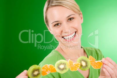 Healthy lifestyle - woman eating kiwi and orange