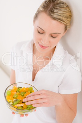 Healthy lifestyle - woman holding bowl with fruit salad