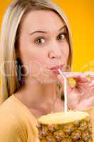 Healthy lifestyle - woman drink juice from pineapple