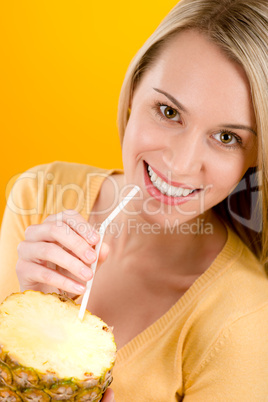 Healthy lifestyle - woman drink juice from pineapple