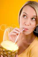 Healthy lifestyle - woman drink juice from pineapple