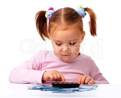 Little girl plays with money