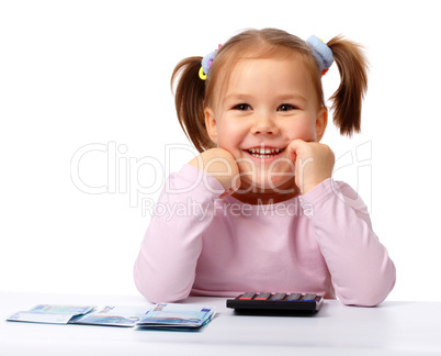 Little girl with few paper euro banknotes