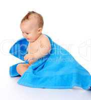 Cute child wrapped in blue towel