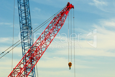 two construction cranes over blue sky