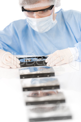 Female computer engineer - woman repair hard disc, sterile