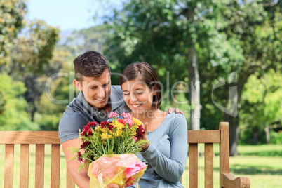 Young man offering flowers to his girlfriend