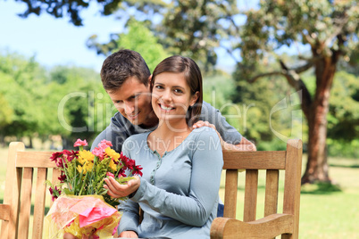 Young man offering flowers to his girlfriend