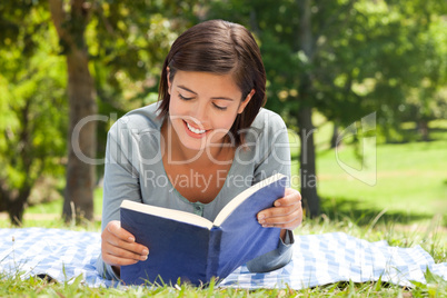 Woman reading a book in the park