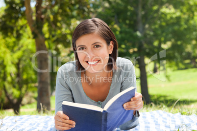 Woman reading a book in the park