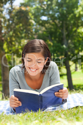 Woman reading a book in the park