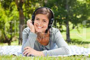 Woman listening to some music in the park