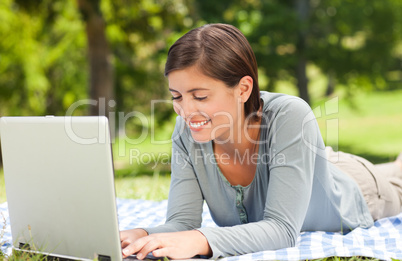 Woman working on her laptop in the park