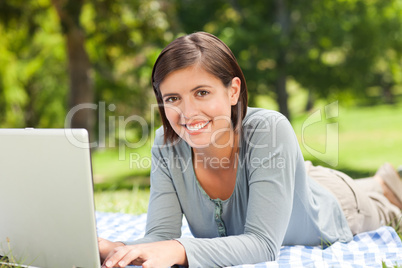 Woman working on her laptop in the park