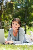 Woman working on her laptop in the park