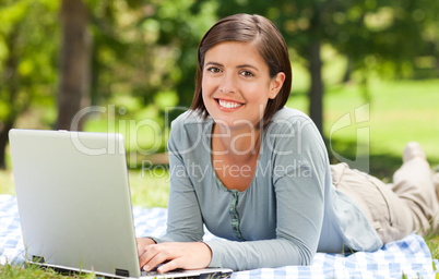 Woman working on her laptop in the park
