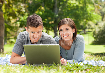 Lovers working on their laptop