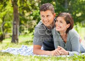 Couple lying down in the park