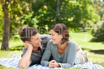 Couple lying down in the park