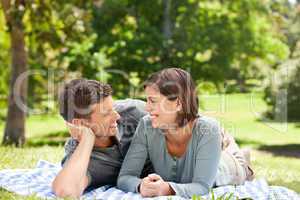 Couple lying down in the park