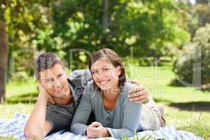 Couple lying down in the park