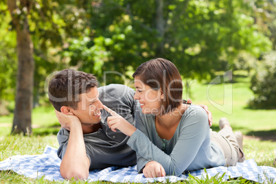 Couple lying down in the park